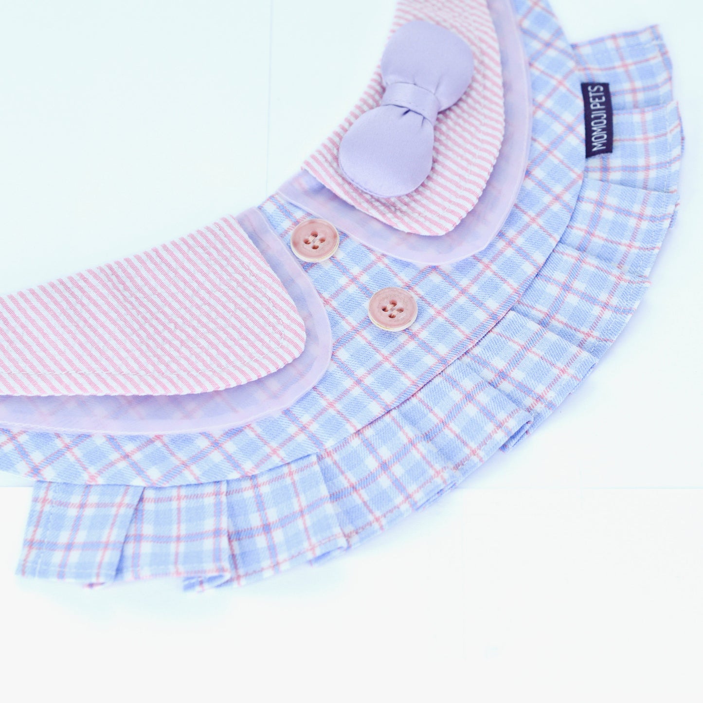 Evelyn blue plaid bandana laid open, showing the pleats