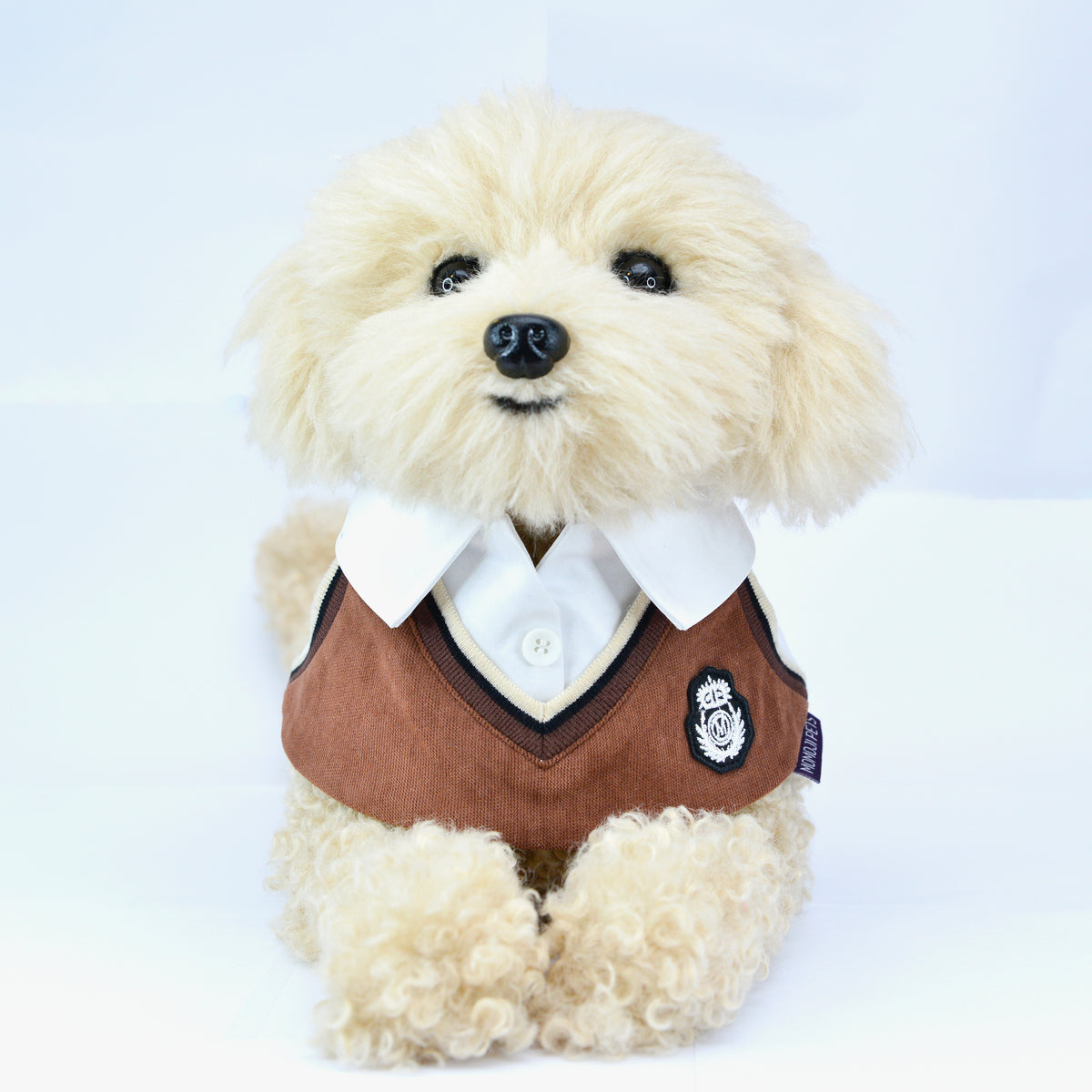 Cream fluffy puppy wearing the Brown Bear Leighton Boys sweater vest bandana