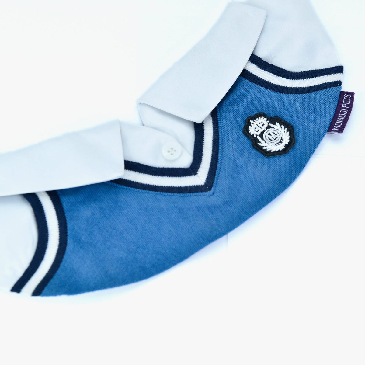 Close-up of the Faded Blue Leighton Boys bandana's crest badge and V-neck stripes