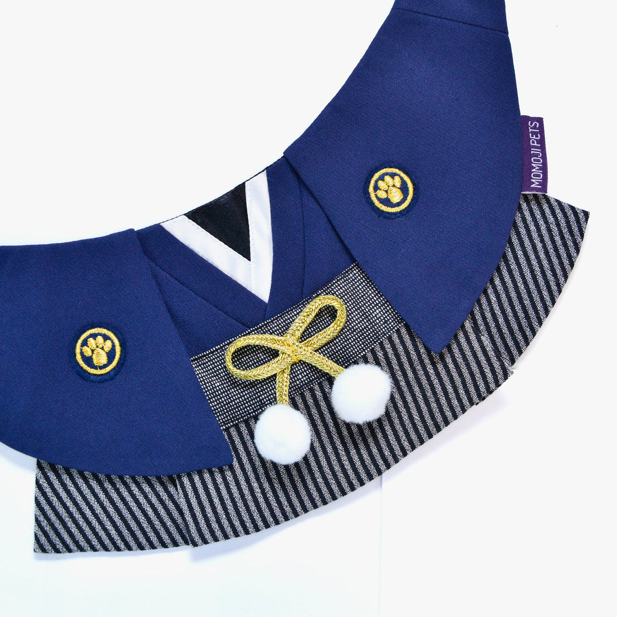 Close-up of the Nippori bandana's crest, gold cord and pom-poms