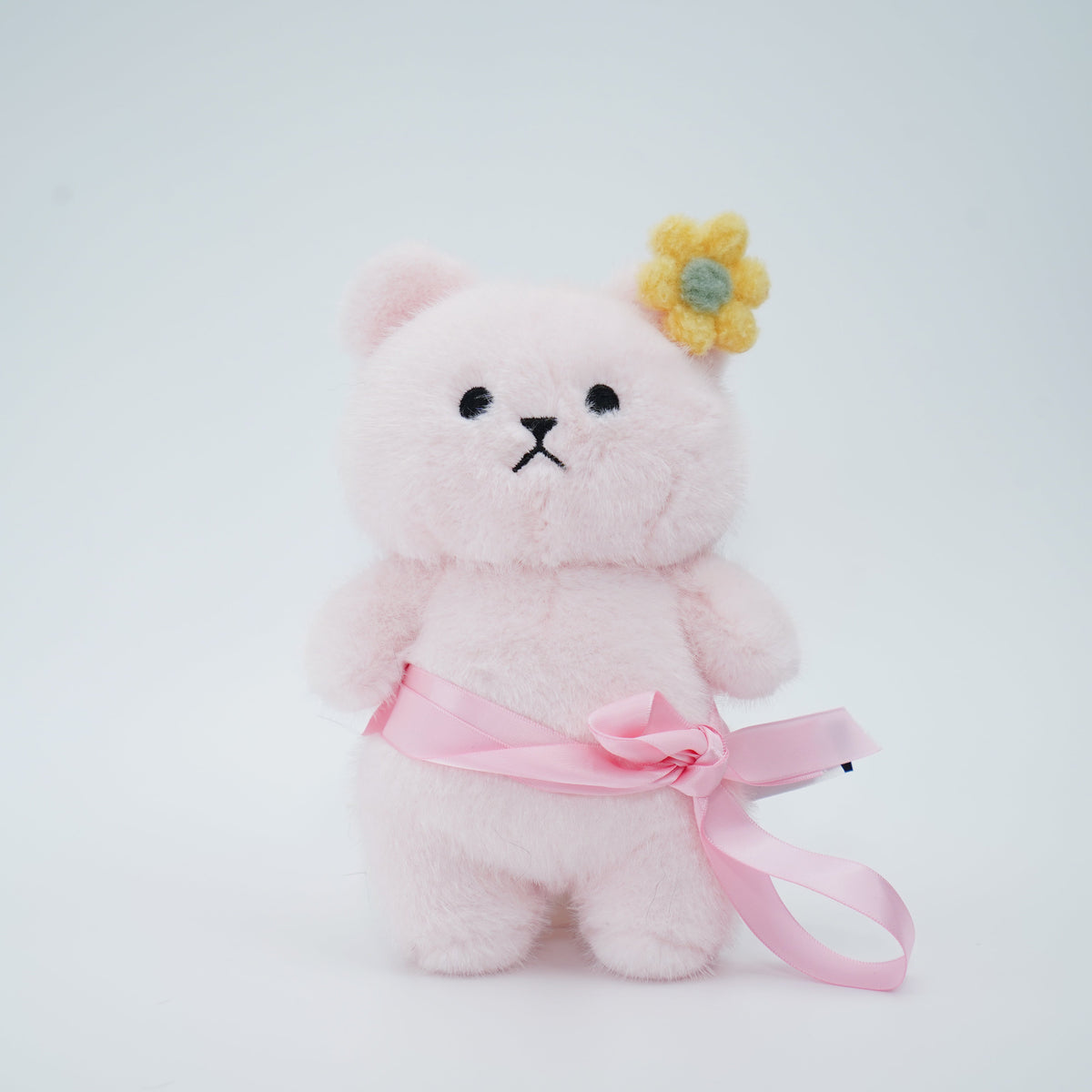 Pink Momoji Bear plush with pink sash and yellow flower clip
