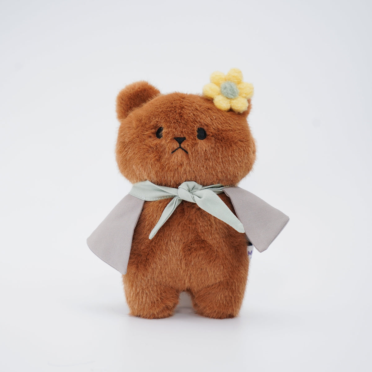 Brown Momoji Bear plush with grey cape and yellow flower clip