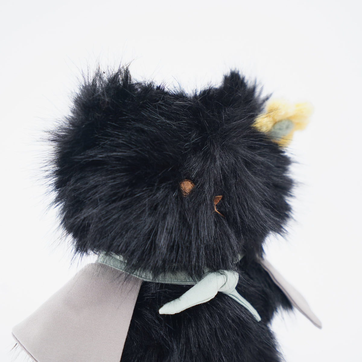 Close-up of the black Momoji Bear plush