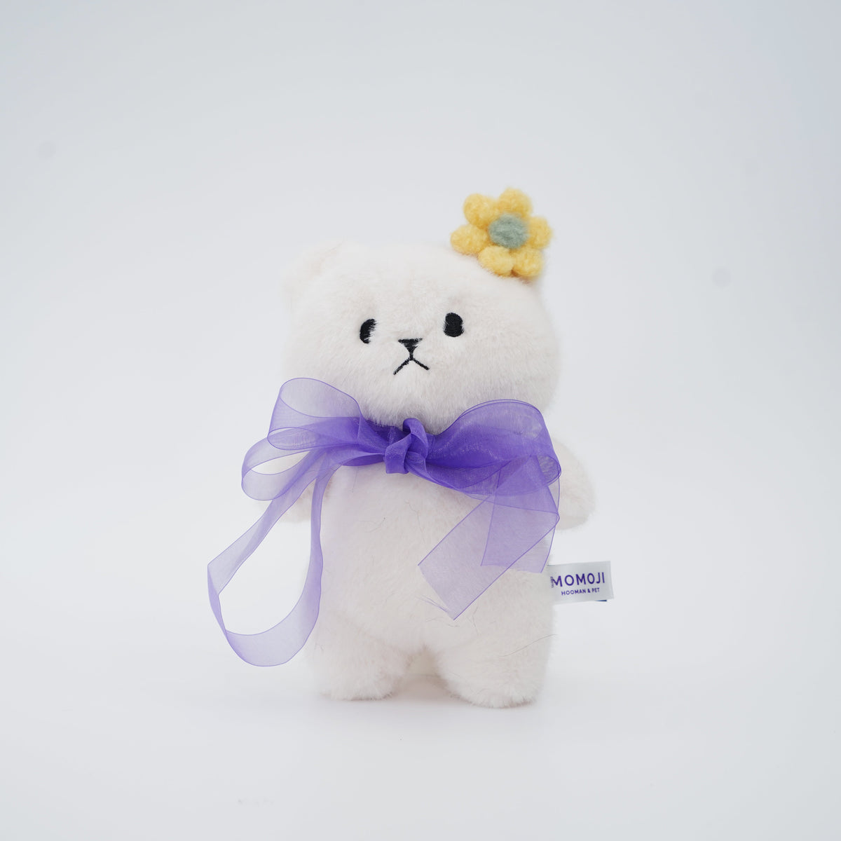 Cream Momoji Bear plush with lilac bow and yellow flower clip