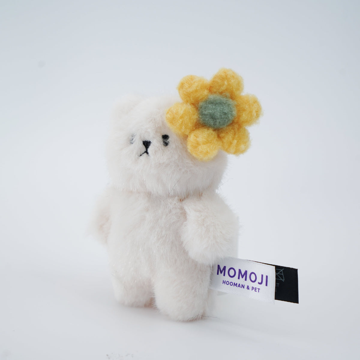 Small cream Momoji Bear plush with yellow flower clip