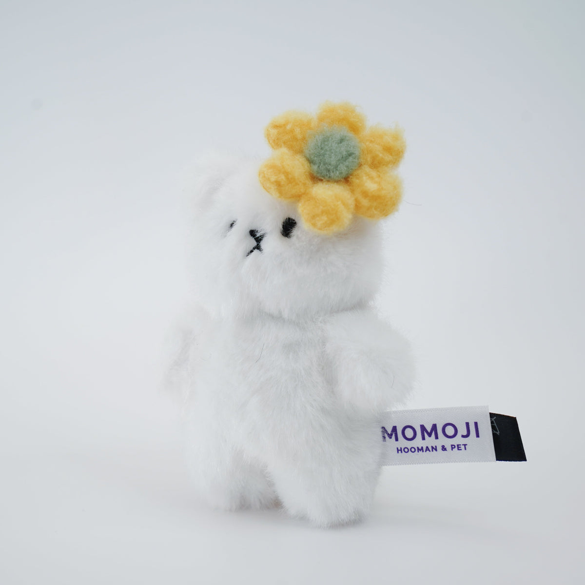 Small white Momoji Bear plush with yellow flower clip