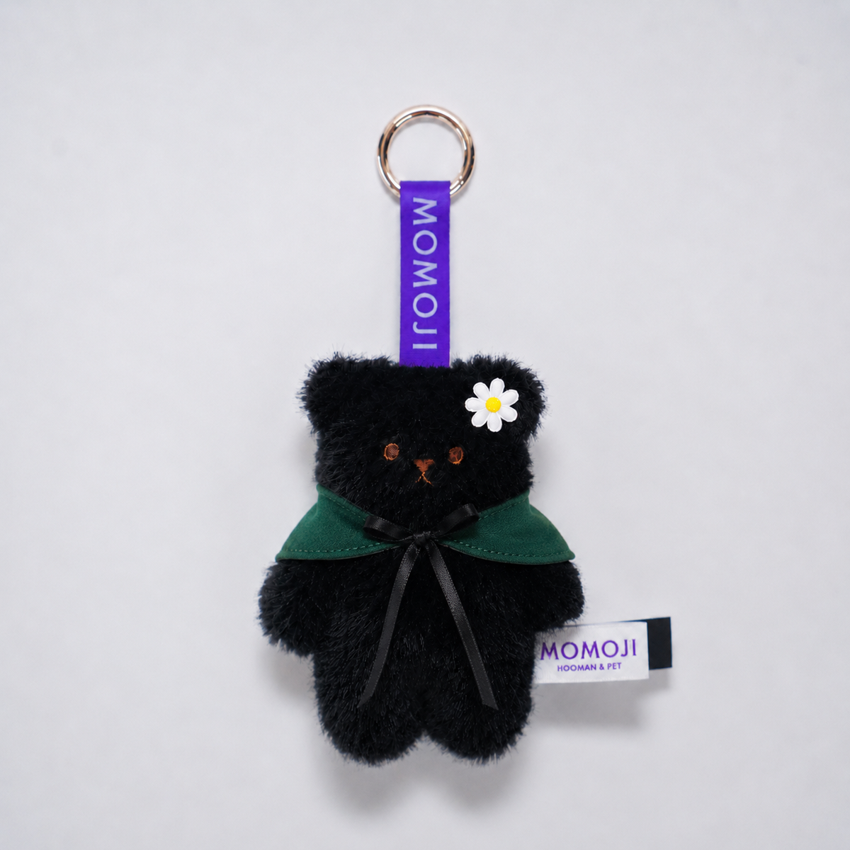 Black Momoji Bear keyring with green cape and flower clip